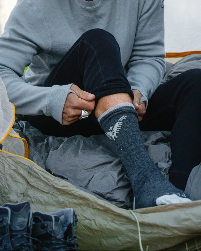 Lower Half of Man Putting on Charcoal / Dark Grey Condór Alpaca Socks in Tent – PAKA Apparel