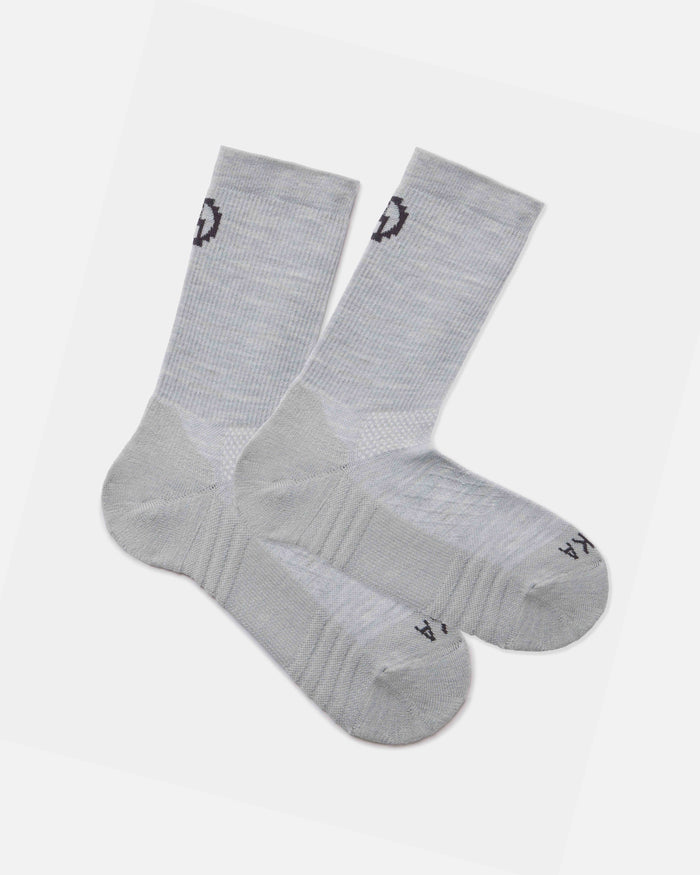 Angled flat lay of Trail Crew socks, light gray alpaca blend with cushioned sole and ribbed crew height on white background