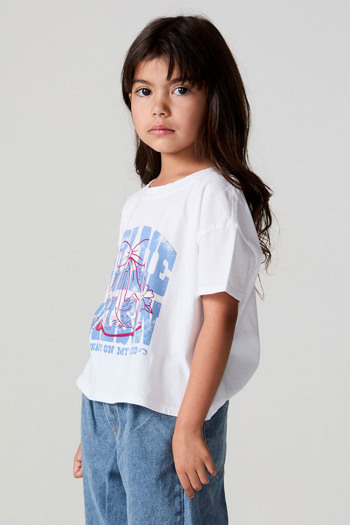 Side angle view of a girl wearing the Chaser Willie Nelson Cowgirl Tee on a neutral background