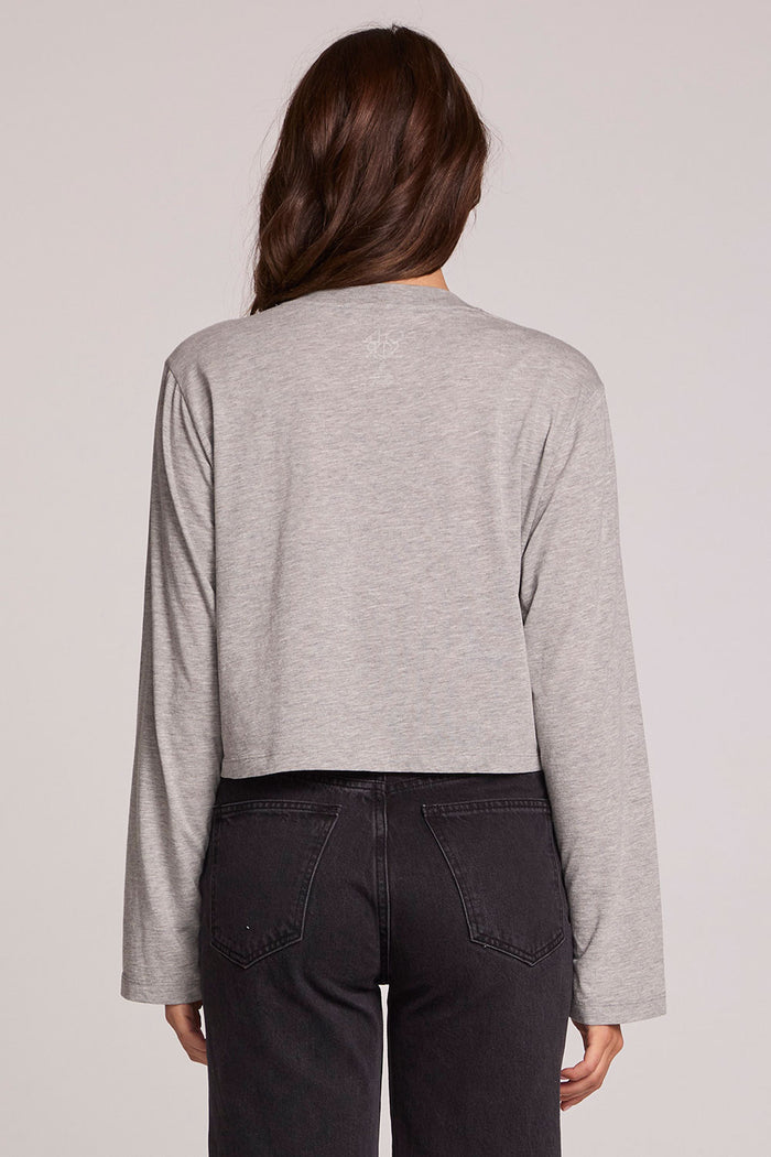 Back view of a woman wearing the Chaser Willie Nelson Horseback Long Sleeve on a neutral background with arms at sides