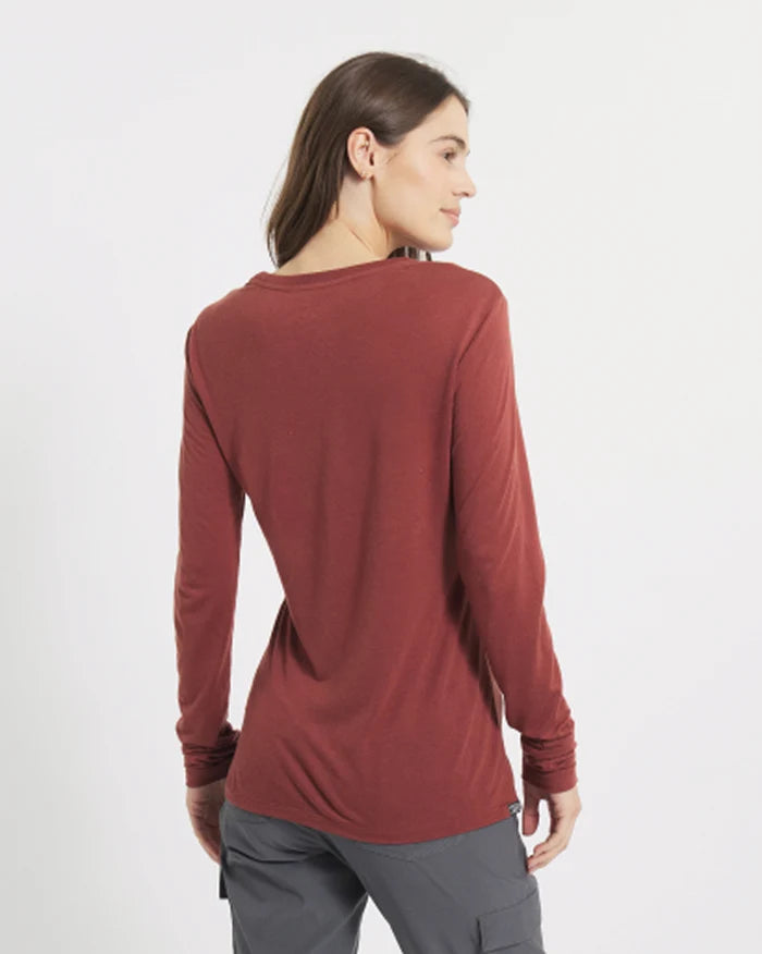 Rear view of Women’s Aire Long Sleeve shirt in clay on a model, slim fit with long sleeves on white background