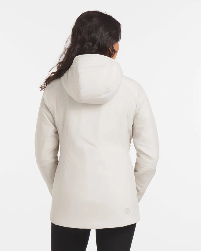 Back view of Women’s Apu Lightweight Puffer showcasing hood and mid-hip length with model on plain white background