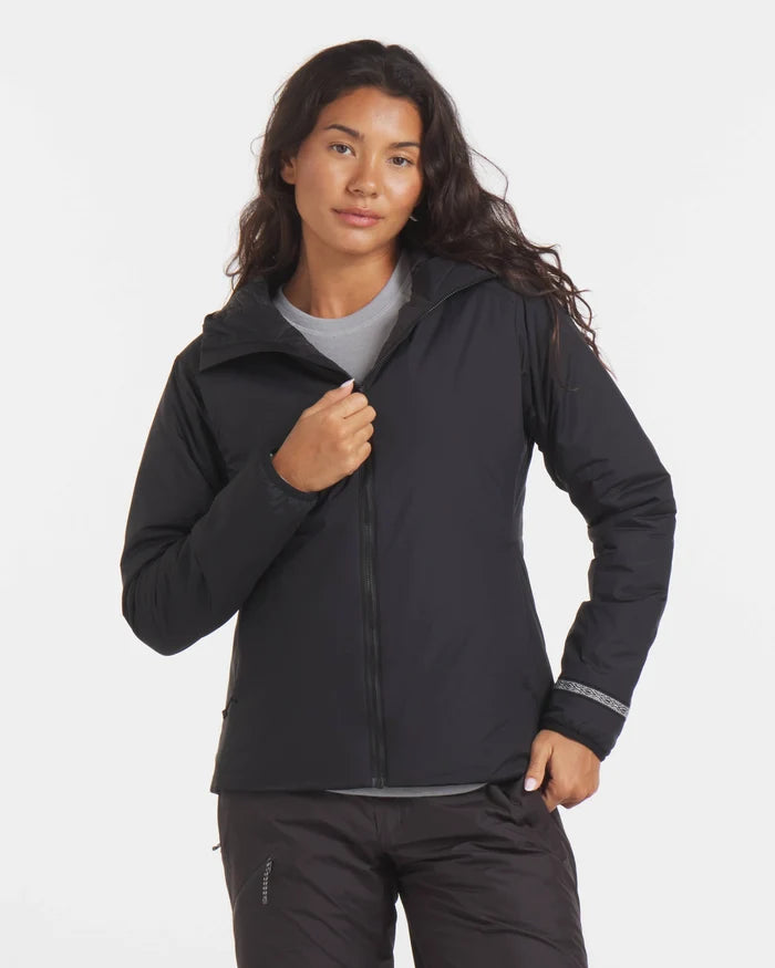 Front view of Women’s Apu Lightweight Puffer jacket in black on model, hooded zip front, slim fit, alpaca-insulated