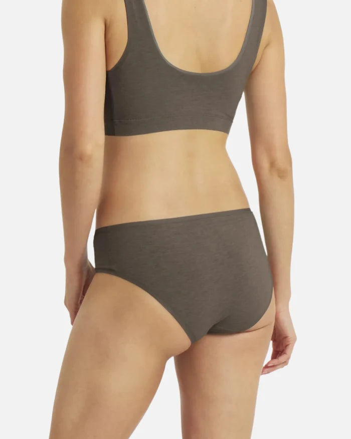 Back view of Women’s Essential Mid-Rise Brief in Forage on model showing full coverage, smooth seams and breathable alpaca fabric on light background
