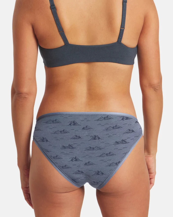 Person wearing a blue bikini with a subtle pattern on a white background