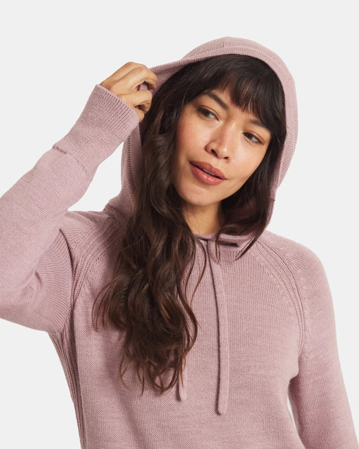 Three-quarter front view of women’s dusty pink alpaca hoodie showing hood with drawstrings, relaxed fit, soft knit on white
