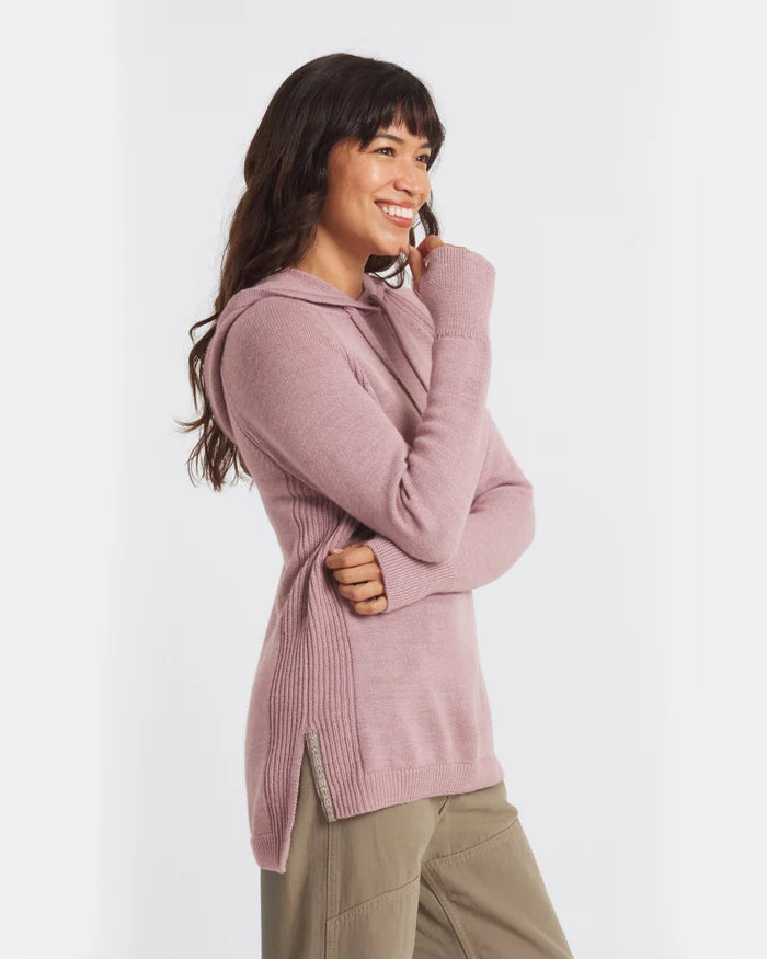 Side view of women’s alpaca hoodie showcasing ribbed side panels, thumbhole cuffs, side zip hem and hood, modeled against white background