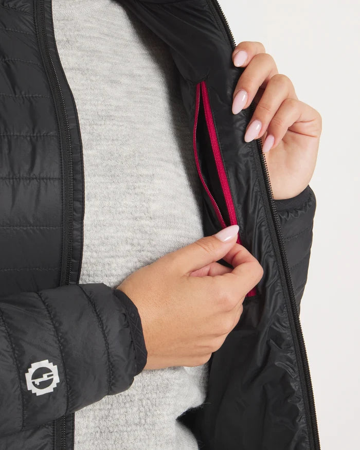 Close-up of Women’s Mayu Ultralight Jacket showing interior zip chest pocket with red trim and model’s hands against a light gray top