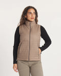 Front view of Women’s Mayu Ultralight Vest in fossil on model, showing high collar and zip pockets on light background
