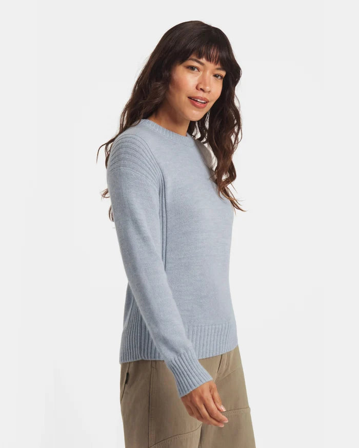 3/4 view of Women’s Original Crew alpaca crew in sky blue on model, showing ribbed hem, cuffs and shoulder ribs