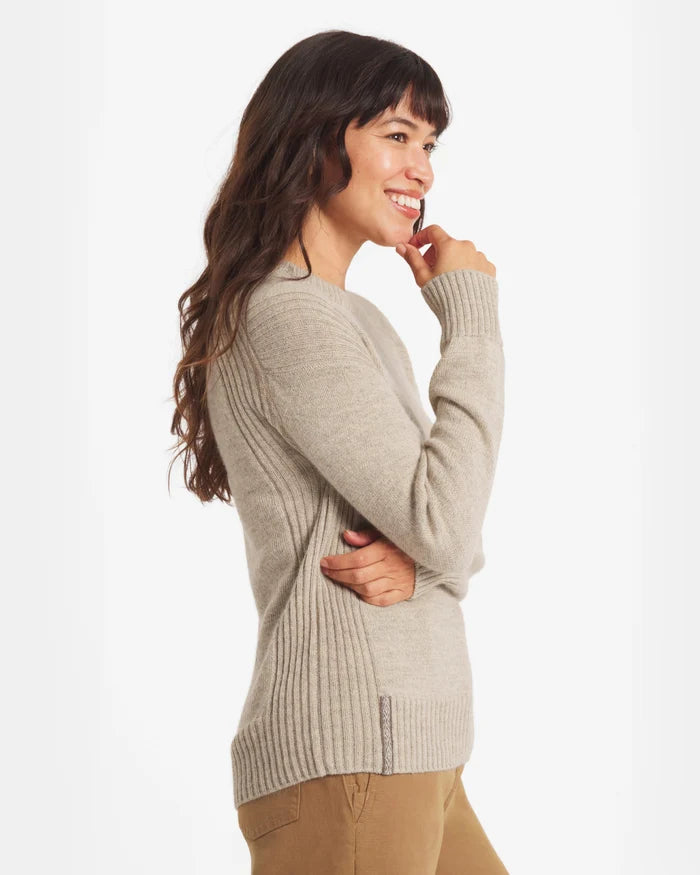 Woman wearing the Women's Original Crew in Pebble sweater on a white background