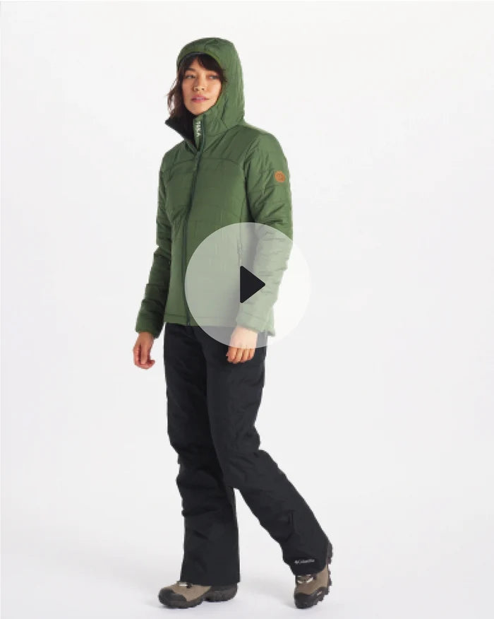 Three-quarter view of women’s PAKAFILL puffer jacket in green showing hood and quilted insulation on model against white