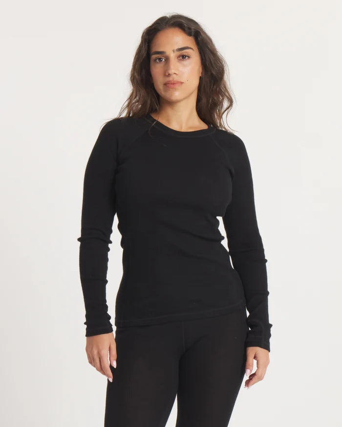 Front view of Women’s Thermal Crew alpaca baselayer in black, slim fit with long sleeves on white background