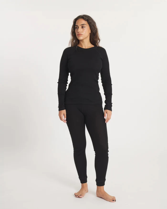 Front view of Women’s Thermal Crew black alpaca baselayer on model showing slim fit, raglan sleeves, and thumbholes