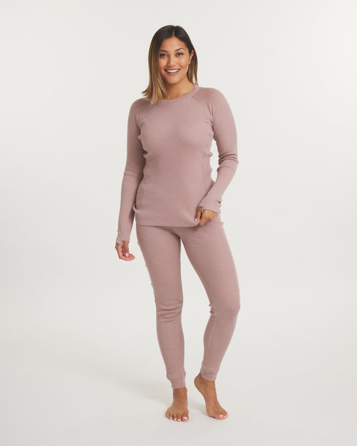 Front view of Women’s Thermal Crew alpaca baselayer in magnolia on model, slim fit with thumbholes on white background