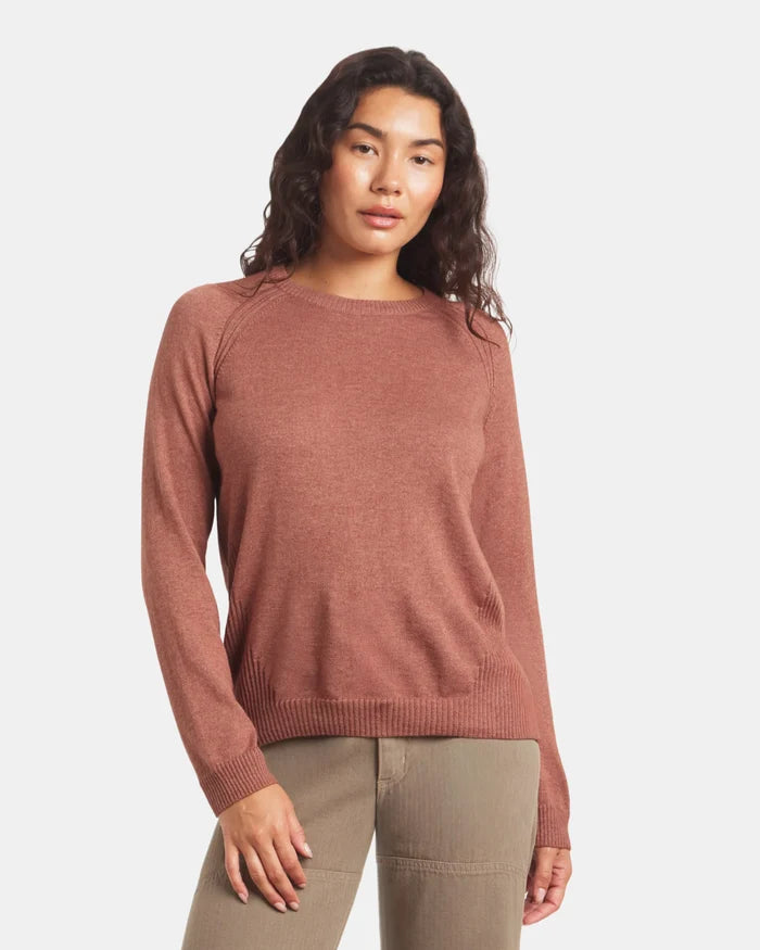 Woman wearing a cinnamon sweater on a white background