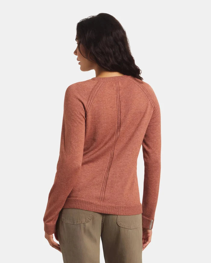 Woman wearing a rust-colored sweater on a white background